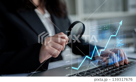 Business professional analyzing financial data on digital screen with charts and graphs representing growth and performance metrics in modern office environment Scalp 139317676