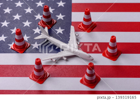 A mock up of airplane with no fly signs on a US flag as a concept for a flight ban A mock up of airplane with no fly signs on a US flag as a concept for a flight ban 139319165