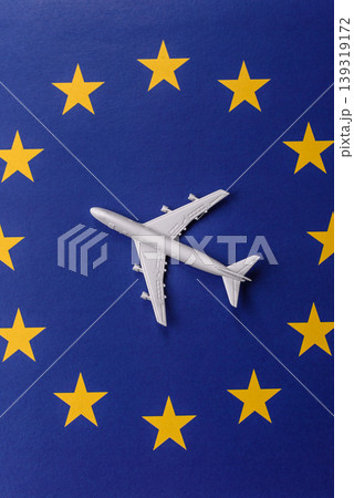 An airplane on the EU flag as a conceptual backdrop for flights and travel. An airplane on the flag An airplane on the EU flag as a conceptual backdrop for flights and travel. An airplane on the flag 139319172
