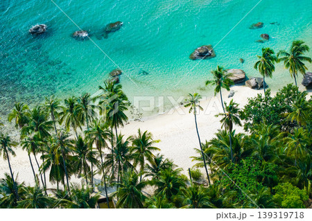 High angle shot of a tropical coastline with palm trees and turquoise water in Koh Kood High angle shot of a tropical coastline with palm trees and turquoise water in Koh Kood 139319718