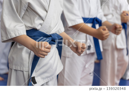 Close-up of young karate students in white gi Close-up of young karate students in white gi 139320348