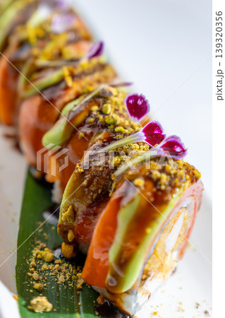 Gourmet sushi roll with shrimp tempura, salmon, and avocado. Gourmet sushi roll with shrimp tempura, salmon, and avocado. 139320356