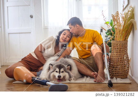 Cozy indoor scene with a couple and their fluffy dog 139321282