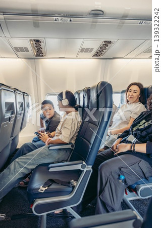 family traveling by airplane sitting in cabin air travel and vacation concept family traveling by airplane sitting in cabin air travel and vacation concept 139322242