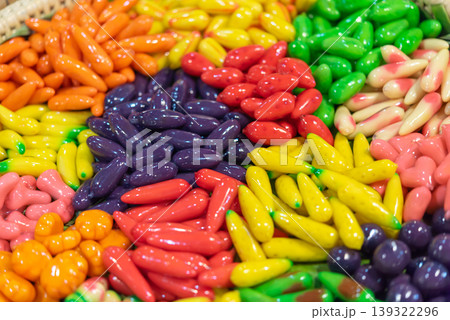 Colorful look choup Thai dessert shaped like miniature fruits with glossy finish made from mung bean paste sweet traditional confectionery vibrant display Colorful look choup Thai dessert shaped like miniature fruits with glossy finish made from mung bean paste sweet traditional confectionery vibrant display 139322296