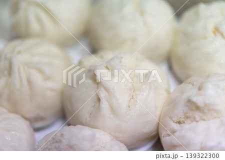 Closeup steamed pork buns soft fluffy texture white bao dim sum style traditional asian food freshly cooked warm and ready to eat delicious snack Closeup steamed pork buns soft fluffy texture white bao dim sum style traditional asian food freshly cooked warm and ready to eat delicious snack 139322300
