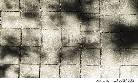 Square wooden block pavement with soft tree shadows, suitable for architectural or design projects. Square wooden block pavement with soft tree shadows, suitable for architectural or design projects. 139324632