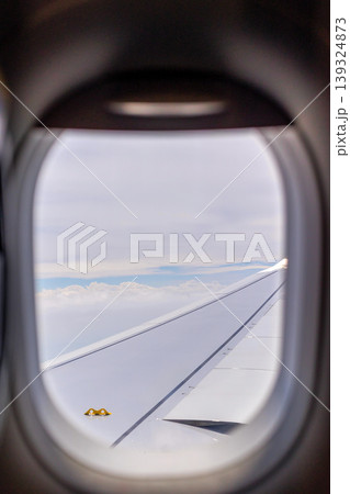 View through airplane window, passenger seat, wing 139324873