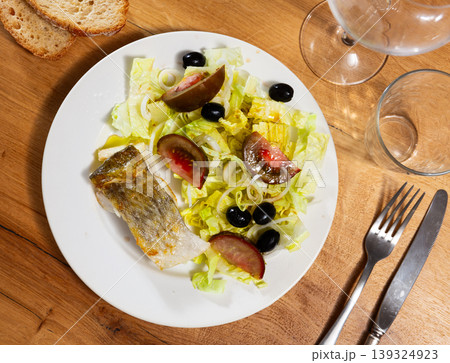 Bacalhau fillet served with fresh vegetable salad 139324923