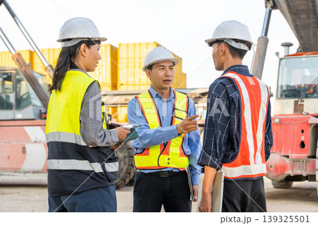 Asian Port Supervisor Giving Directions to Logistics Team at Thailand Container Terminal Yard Asian Port Supervisor Giving Directions to Logistics Team at Thailand Container Terminal Yard 139325501