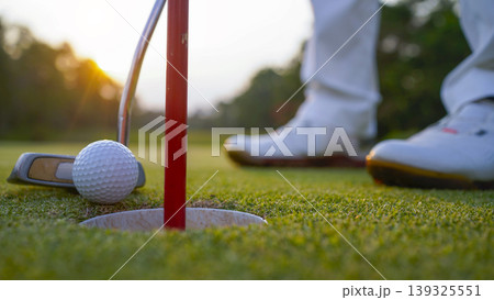 Golfers are putting golf in the evening golf course golf backglound. 139325551