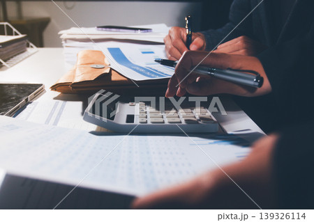 Professional photo of a person's hands reviewing a contract or legal document on a desk, for concepts of business, finance, and legal affairs Professional photo of a person's hands reviewing a contract or legal document on a desk, for concepts of business, finance, and legal affairs 139326114
