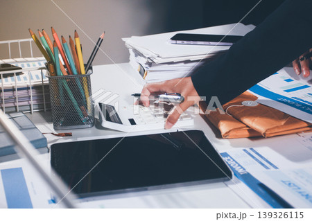 Professional photo of a person's hands reviewing a contract or legal document on a desk, for concepts of business, finance, and legal affairs Professional photo of a person's hands reviewing a contract or legal document on a desk, for concepts of business, finance, and legal affairs 139326115