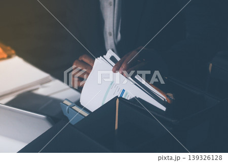 Professional photo of a person's hands reviewing a contract or legal document on a desk, for concepts of business, finance, and legal affairs Professional photo of a person's hands reviewing a contract or legal document on a desk, for concepts of business, finance, and legal affairs 139326128