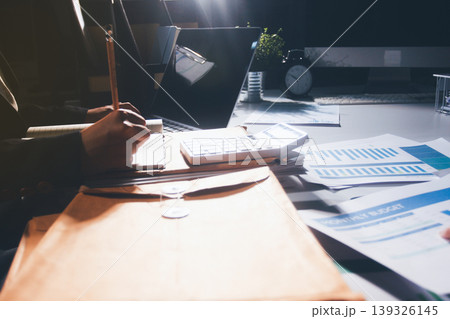 Professional photo of a person's hands reviewing a contract or legal document on a desk, for concepts of business, finance, and legal affairs Professional photo of a person's hands reviewing a contract or legal document on a desk, for concepts of business, finance, and legal affairs 139326145