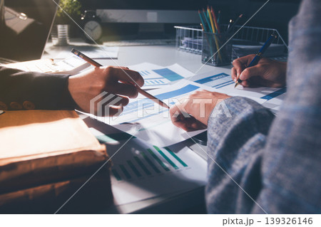Professional photo of a person's hands reviewing a contract or legal document on a desk, for concepts of business, finance, and legal affairs Professional photo of a person's hands reviewing a contract or legal document on a desk, for concepts of business, finance, and legal affairs 139326146