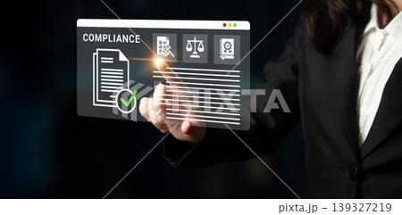 Business Professional Interacting with Digital Compliance Interface Displaying Documents, Checks, and Legal Symbols in Futuristic Workspace Ledger Business Professional Interacting with Digital Compliance Interface Displaying Documents, Checks, and Legal Symbols in Futuristic Workspace Ledger 139327219