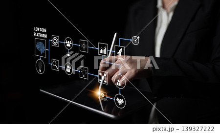 Business Professional Interacting with Low Code Platform on Tablet in Dark Environment, Showcasing Modern Technology and Digital Innovation Strategies Quark Business Professional Interacting with Low Code Platform on Tablet in Dark Environment, Showcasing Modern Technology and Digital Innovation Strategies Quark 139327222