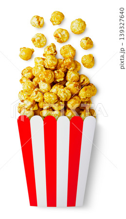 Caramel popcorn spilled out of the box on a white background. Top view Caramel popcorn spilled out of the box on a white background. Top view 139327640