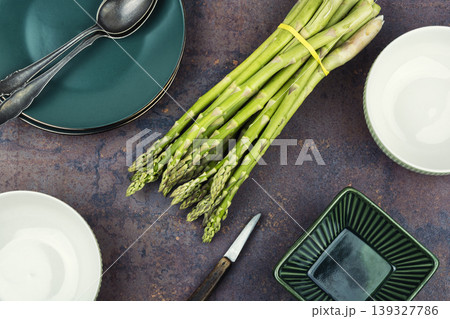 Raw green asparagus bunch on light kitchen background Raw green asparagus bunch on light kitchen background 139327786
