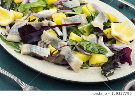 Herring salad with boiled potatoes, onion and fresh greens Herring salad with boiled potatoes, onion and fresh greens 139327790