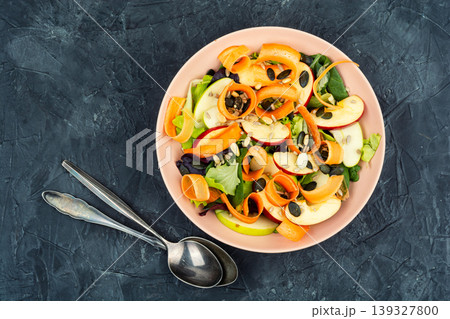 Fresh plant based salad bowl with apple carrot ribbons and greens Fresh plant based salad bowl with apple carrot ribbons and greens 139327800