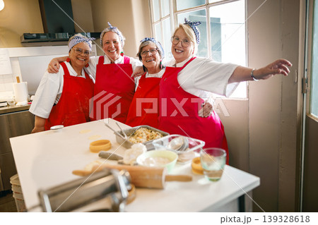 Group of four joyful senior women posing and laughing in a kitchen workshop Group of four joyful senior women posing and laughing in a kitchen workshop 139328618