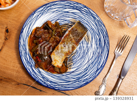Fried cod fish garnished with vegetable ragout Fried cod fish garnished with vegetable ragout 139328931