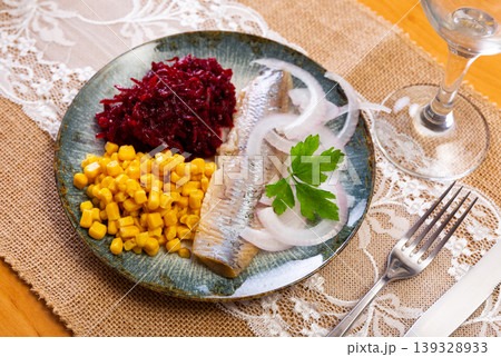 Herring served on plate with grated beetroot and corn Herring served on plate with grated beetroot and corn 139328933