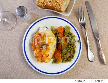 Fried cod fish garnished with vegetable ragout Fried cod fish garnished with vegetable ragout 139328940
