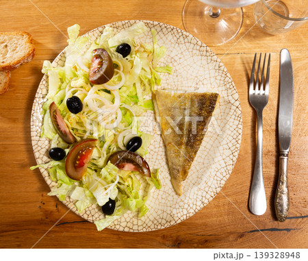 Bacalhau fillet served with fresh vegetable salad Bacalhau fillet served with fresh vegetable salad 139328948