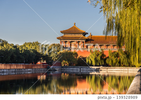 Sunrise view of Forbidden City watch tower next to surrounding scenic moat to ensure security of the palace. 139328989