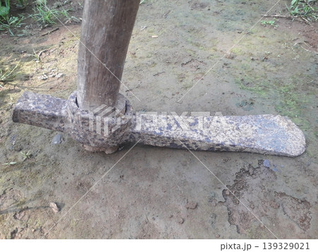 Close up of a rusty metal blade of a traditional Indonesian Ganco digging tool. Close up of a rusty metal blade of a traditional Indonesian Ganco digging tool. 139329021