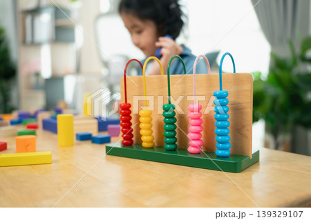 Colorful Abacus with Wooden Blocks in Background, Child Playing, Learning Through Play, Educational Toys for Kids, Cognitive Development Tools Colorful Abacus with Wooden Blocks in Background, Child Playing, Learning Through Play, Educational Toys for Kids, Cognitive Development Tools 139329107