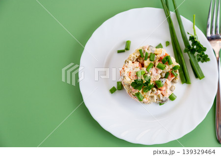festive olivier salad served on white plate with fresh herbs festive olivier salad served on white plate with fresh herbs 139329464