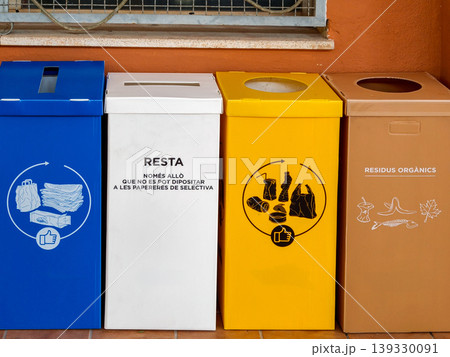 Recycling bins in a row separating waste 139330091