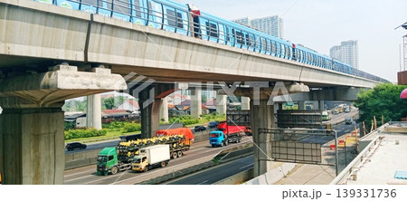 Blue Skytrain Passes Over Busy Toll Road Blue Skytrain Passes Over Busy Toll Road 139331736
