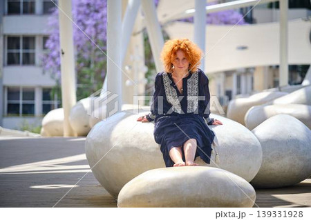 Fashion lifestyle portrait of red haired woman on urban bridge in sunlight Fashion lifestyle portrait of red haired woman on urban bridge in sunlight 139331928