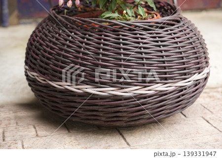 Large bulbous wicker floor planter with white accent weave band 139331947