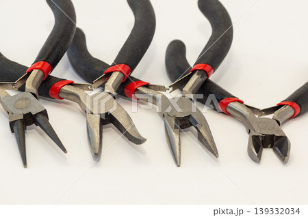 Set of different types of pliers and side cutters isolated on black background. Set of different types of pliers and side cutters isolated on black background. 139332034
