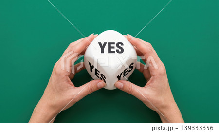 Female Hands Holding White Cube with YES Text Positive Decision and Confidence Concept 139333356