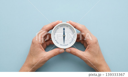 emale Hands Holding Compass with BREATHE Text Mindfulness and Calm Concept 139333367