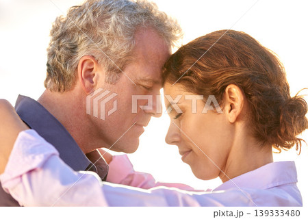 Mature, couple and forehead together with love, support and care in marriage or partnership. Outdoor, man and woman with gratitude, empathy or embrace at sunset on holiday or vacation with happiness Mature, couple and forehead together with love, support and care in marriage or partnership. Outdoor, man and woman with gratitude, empathy or embrace at sunset on holiday or vacation with happiness 139333480