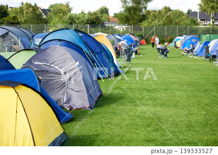 Camping, tents and outdoor music festival in park with people on field with grass or trees in summer. Camp, site and shelter at party, event or travel in woods for concert, adventure and carnival 139333527