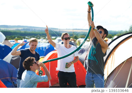 Alcohol, festival or drunk friends drinking together, beer beverage or outdoor social event. Summer music concert, party games celebration or excited people with freedom, hose funnel or pipe tube 139333646