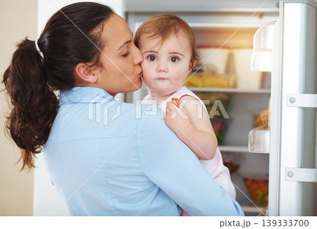Happy woman, mother and toddler with kiss in kitchen, fridge and eating of snack for hunger. Kid, little girl and hungry with fresh, organic or fruit for nutrition, vegetarian or healthy diet in home Happy woman, mother and toddler with kiss in kitchen, fridge and eating of snack for hunger. Kid, little girl and hungry with fresh, organic or fruit for nutrition, vegetarian or healthy diet in home 139333700