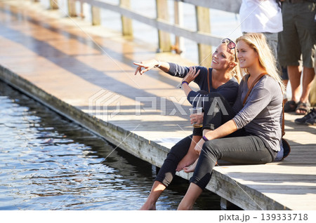 People, drink and holiday at lake with beer, water or deck in summer with women pointing to view. Friends, party and relax at dam with alcohol, chat and fun at social, event or sitting on pier People, drink and holiday at lake with beer, water or deck in summer with women pointing to view. Friends, party and relax at dam with alcohol, chat and fun at social, event or sitting on pier 139333718