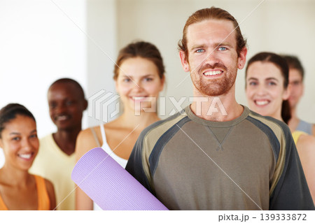 Portrait, yoga mat or class and man with a group of people in a fitness studio for health, wellness or mindfulness. Workout, training or pilates with happy young friends in gym for holistic exercise Portrait, yoga mat or class and man with a group of people in a fitness studio for health, wellness or mindfulness. Workout, training or pilates with happy young friends in gym for holistic exercise 139333872