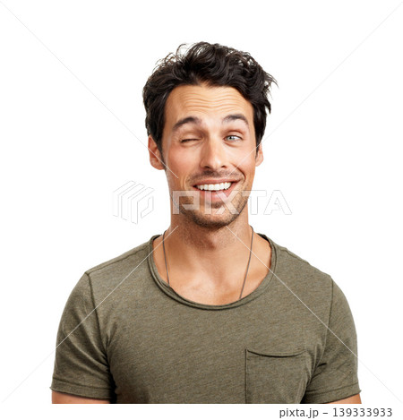 Face, smile and playful wink with a man in studio isolated on a white background for comedy or humor. Comic, funny and happy with a goofy young person acting silly as a character for a carefree joke 139333933