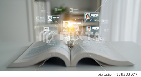 An open book with a glowing light bulb represents knowledge and learning, while floating digital profiles highlight modern information-sharing in an inspiring work environment. Sigmoid An open book with a glowing light bulb represents knowledge and learning, while floating digital profiles highlight modern information-sharing in an inspiring work environment. Sigmoid 139333977